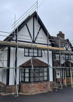 Large detached home with scaffolding