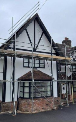 Large detached home with scaffolding