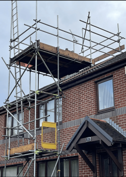 Domestic home with scaffolding for roof access