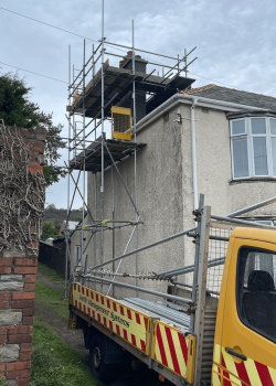 Side of home with scaffolding, access to the chimney