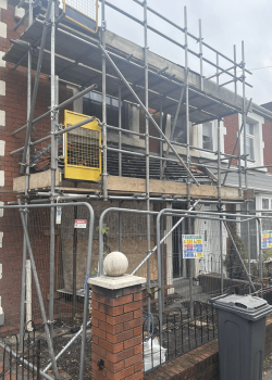 Row of houses, one in scaffolding