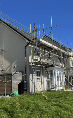 Row of houses, one covered in scaffolding